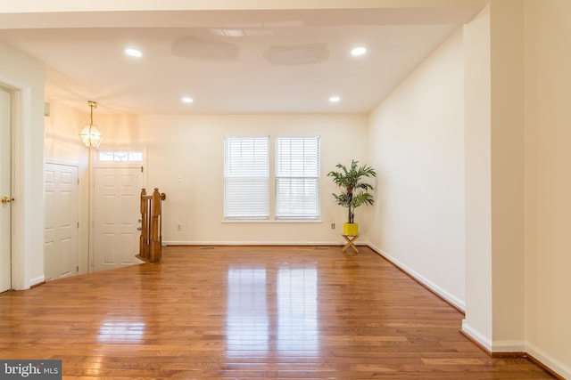 unfurnished room with recessed lighting, baseboards, and wood finished floors