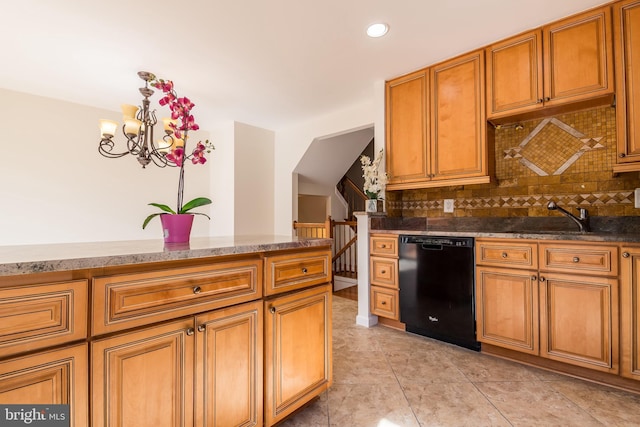 kitchen with a sink, dishwasher, tasteful backsplash, brown cabinetry, and decorative light fixtures