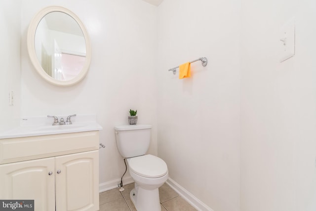 bathroom featuring baseboards, vanity, toilet, and tile patterned floors