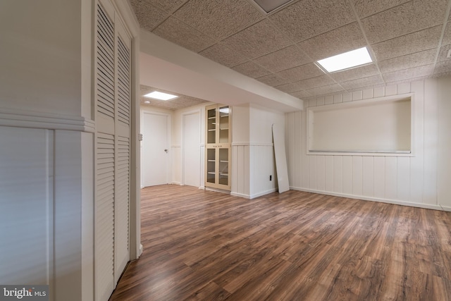 unfurnished room featuring wood finished floors and a paneled ceiling