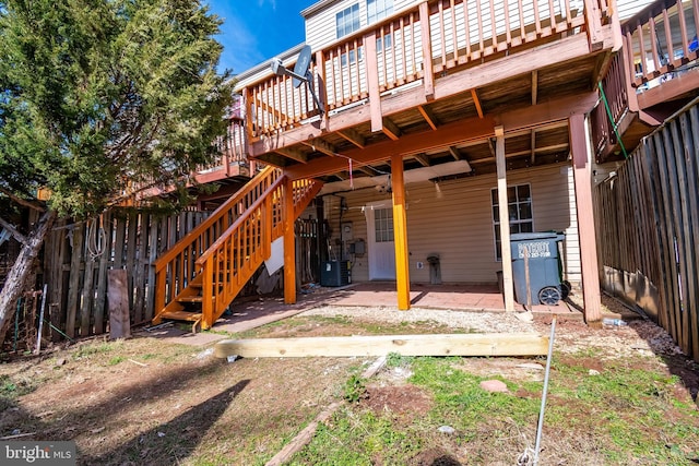 exterior space with a deck, central AC unit, stairway, and fence