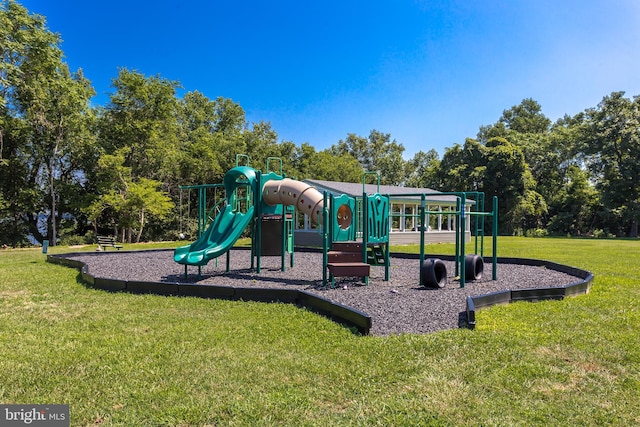 community jungle gym featuring a lawn