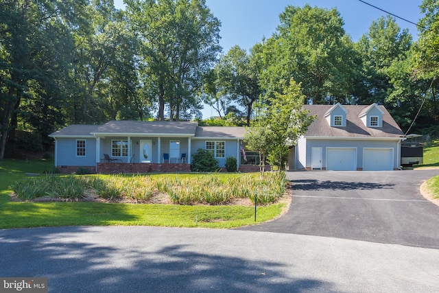 view of front of home with crawl space, an attached garage, driveway, and a front yard