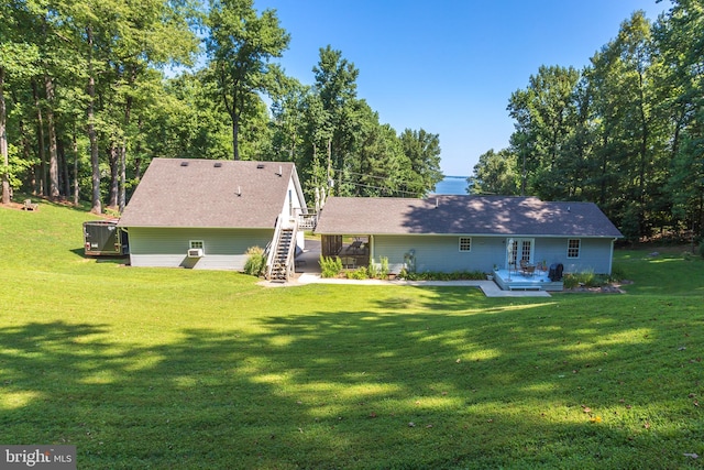 back of property with stairway, a yard, central AC, and a wooden deck