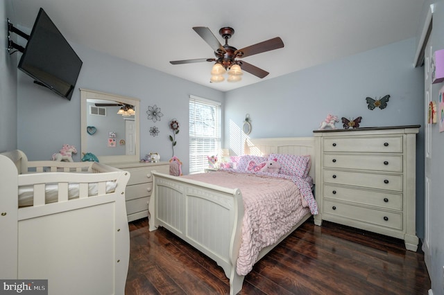 bedroom with visible vents, dark wood finished floors, and a ceiling fan