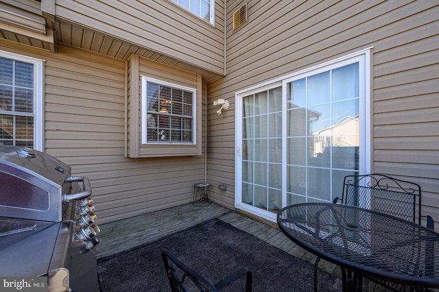 exterior space with outdoor dining area and a grill