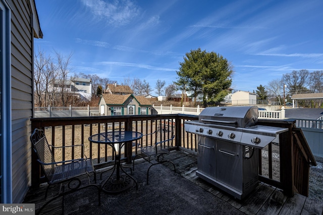 deck with a fenced backyard, a residential view, and an outdoor structure