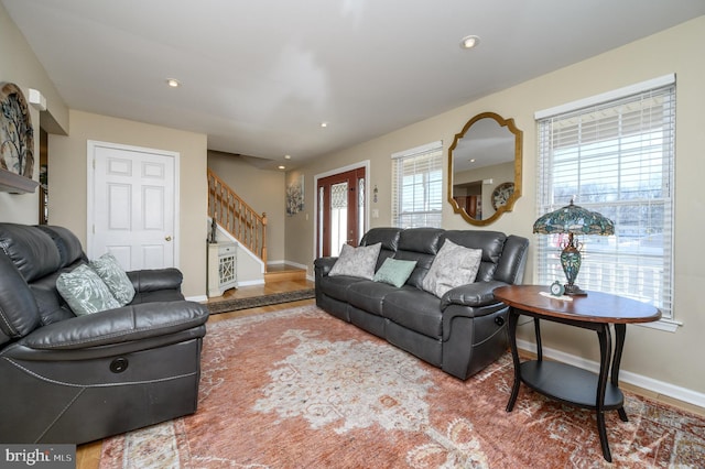 living room with recessed lighting, stairway, and baseboards