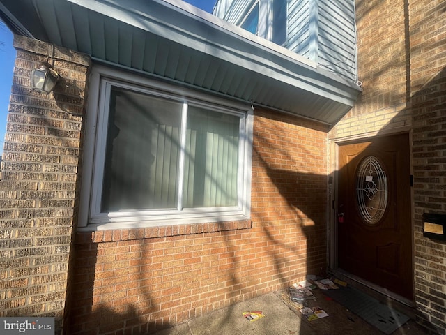 property entrance with brick siding