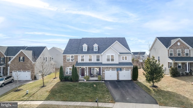 view of front of home with aphalt driveway, a front lawn, a porch, and an attached garage