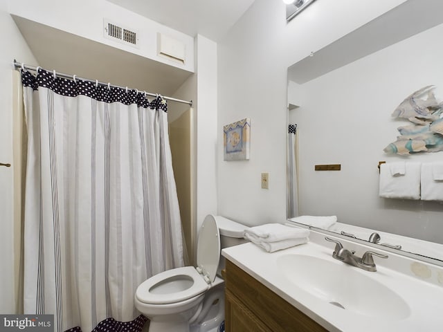 full bath with a shower with shower curtain, visible vents, vanity, and toilet