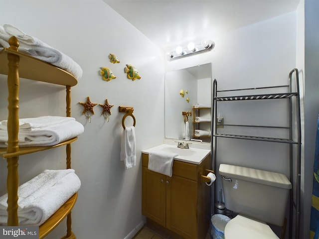 bathroom featuring toilet and vanity