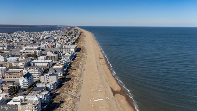 birds eye view of property with a view of city, a water view, and a beach view