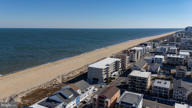 aerial view featuring a view of city, a water view, and a beach view