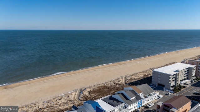 drone / aerial view featuring a water view and a view of the beach