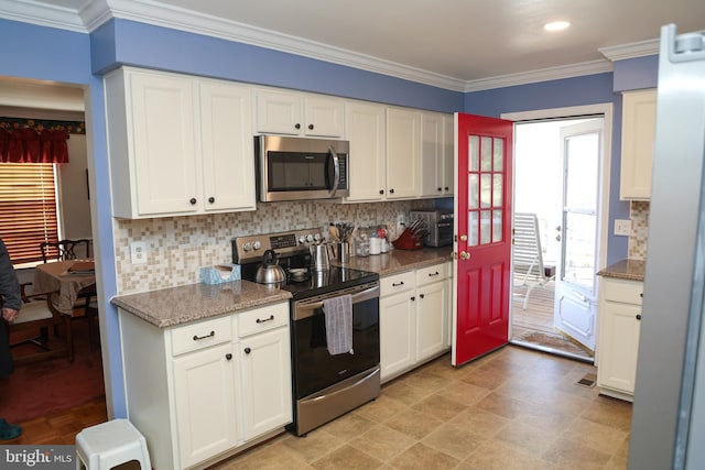 kitchen with tasteful backsplash, white cabinets, stainless steel appliances, and crown molding