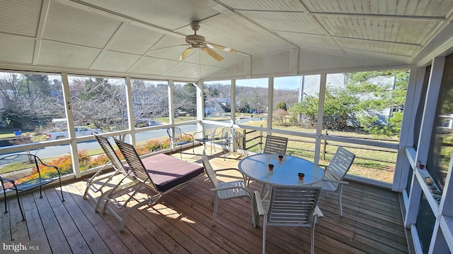 sunroom featuring ceiling fan and vaulted ceiling