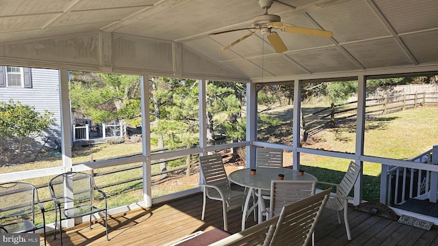 sunroom / solarium with lofted ceiling and a ceiling fan