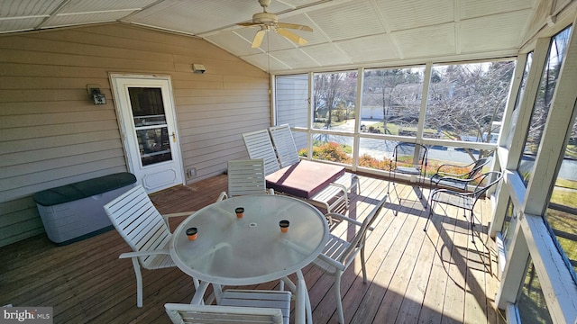 sunroom featuring a ceiling fan and vaulted ceiling