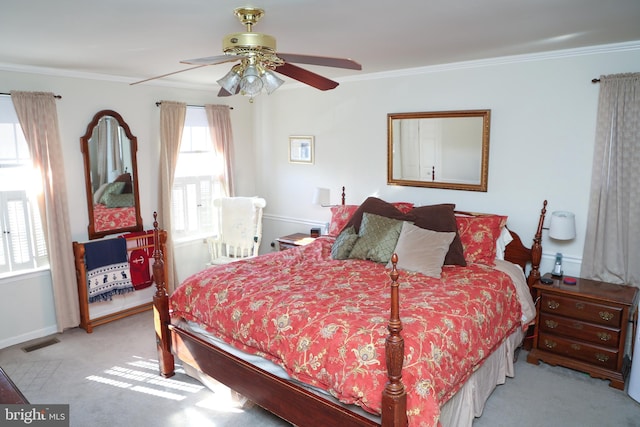 bedroom featuring ceiling fan, visible vents, ornamental molding, and carpet flooring