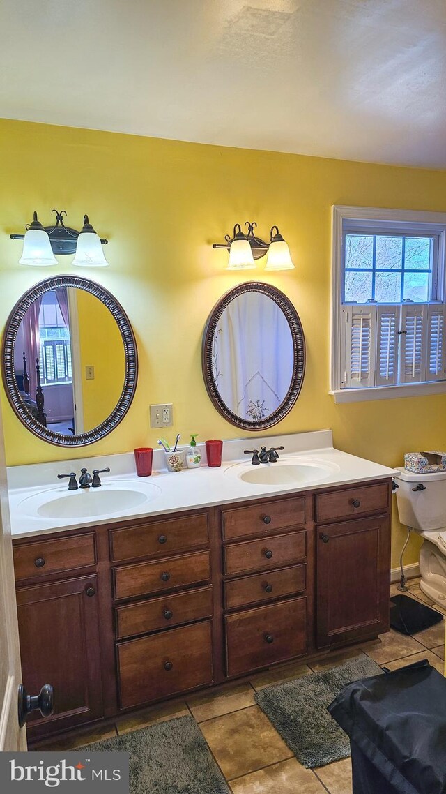 bathroom featuring a sink, double vanity, and tile patterned flooring