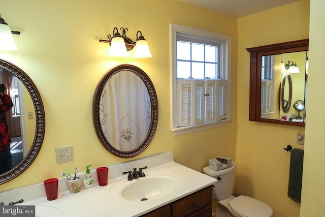 bathroom with toilet and vanity