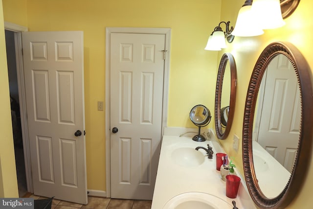 bathroom with a sink, double vanity, and tile patterned flooring