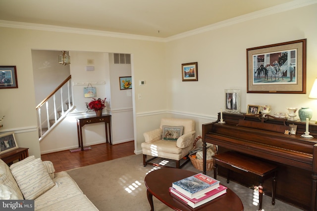 living room featuring visible vents, ornamental molding, and stairway