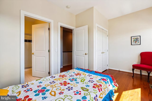 bedroom with baseboards, a closet, and wood finished floors