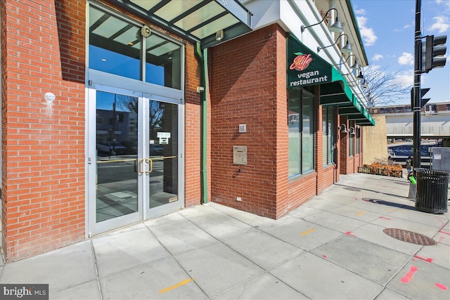 exterior space featuring french doors and brick siding