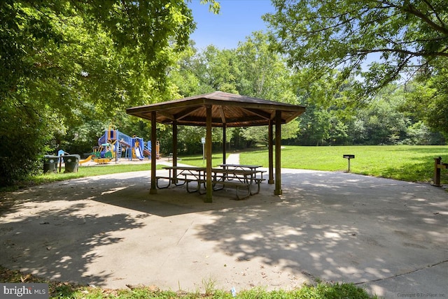 view of property's community featuring playground community, a yard, and a gazebo