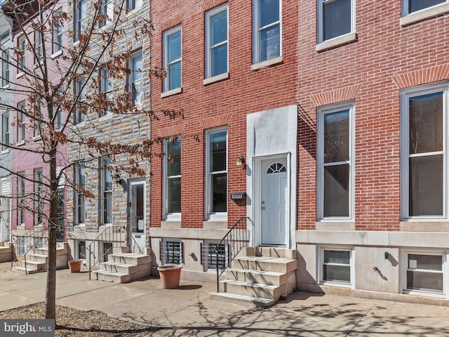 view of exterior entry with brick siding