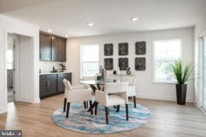 dining space featuring light wood-style flooring and recessed lighting