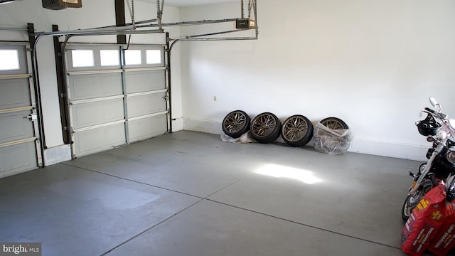 garage featuring baseboards and a garage door opener