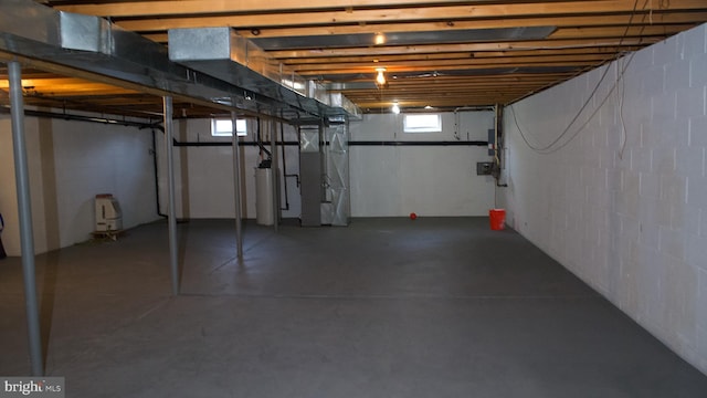 below grade area featuring heating unit and gas water heater