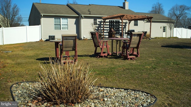 rear view of house featuring a playground, a lawn, a chimney, and fence