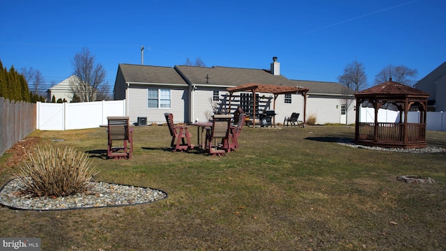 rear view of property with a fenced backyard, a pergola, a lawn, and a gazebo