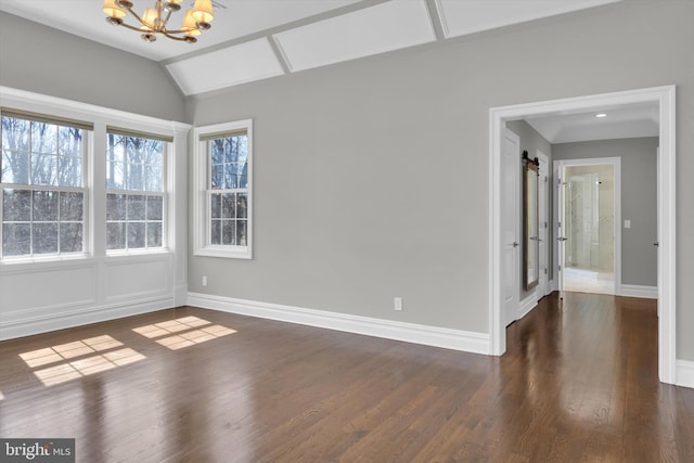 empty room with baseboards, an inviting chandelier, and dark wood finished floors