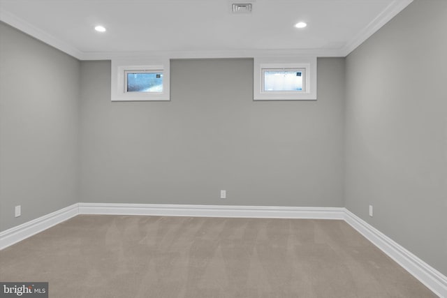 below grade area featuring baseboards, visible vents, a healthy amount of sunlight, and carpet