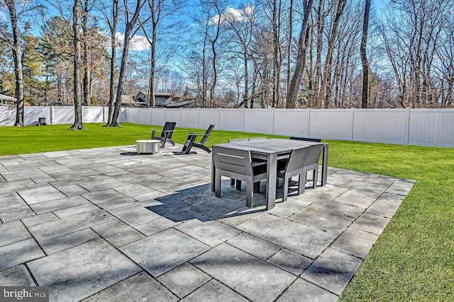 view of patio featuring a fire pit, outdoor dining space, and a fenced backyard