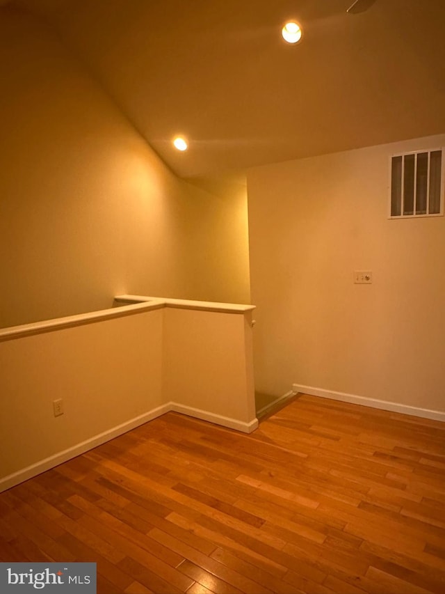 unfurnished room with recessed lighting, visible vents, baseboards, and wood finished floors