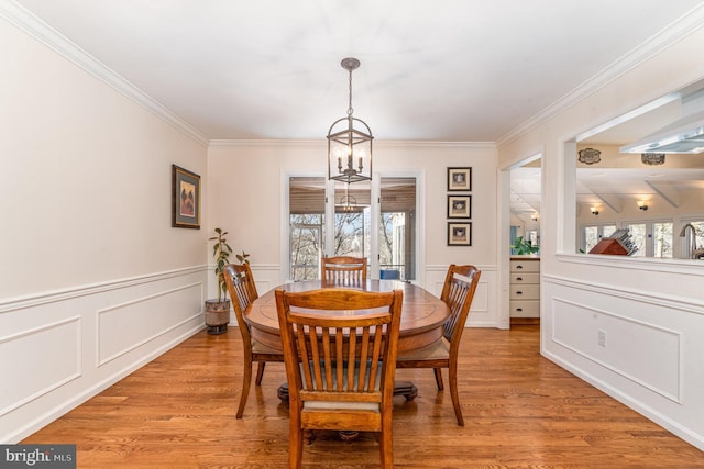 dining space featuring light wood finished floors, plenty of natural light, and a chandelier