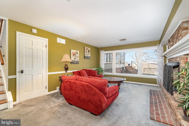 carpeted living room featuring stairs, a fireplace, visible vents, and baseboards