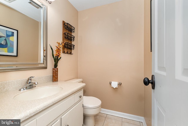 half bathroom featuring vanity, tile patterned flooring, toilet, and baseboards