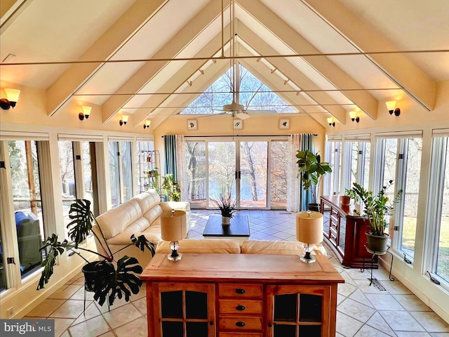 sunroom / solarium featuring vaulted ceiling with beams