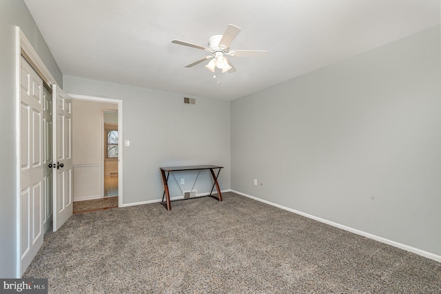 carpeted bedroom with ceiling fan, a closet, visible vents, and baseboards