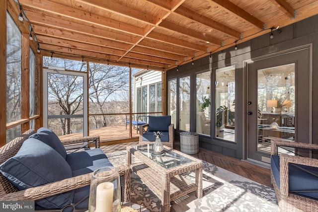 sunroom featuring beam ceiling and wood ceiling