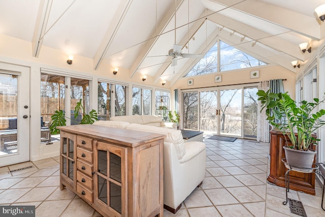 sunroom / solarium with a ceiling fan, visible vents, and lofted ceiling with beams