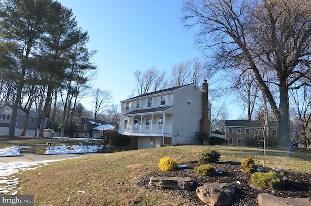 exterior space with a garage, a yard, and a chimney