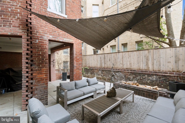 view of patio with an outdoor living space and fence